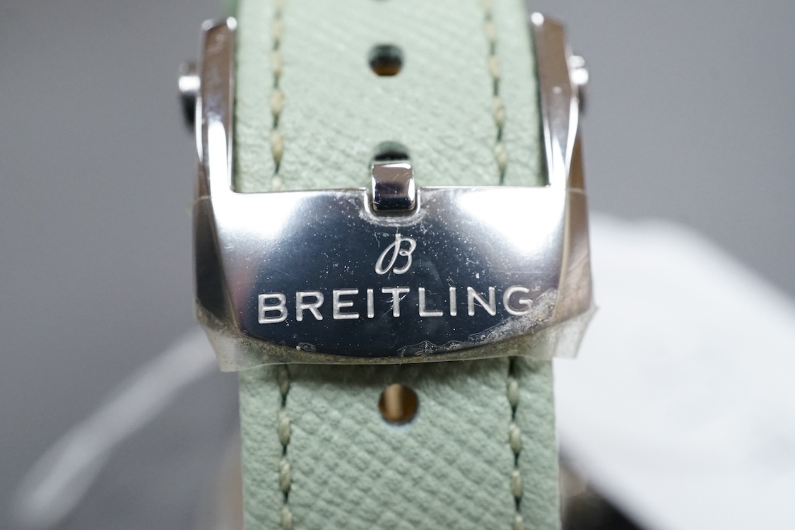 A lady's recent stainless steel Breitling SuperOcean Heritage Automatic cal. 38 57 chronometer wrist watch, with light green dial and baton numerals, case diameter 37mm, on a light green leather strap with Breitling buck